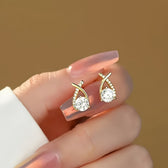 Earrings with golden cross and zirconia