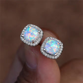 Elegant silver earrings with round white fire opals