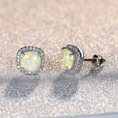 Elegant silver earrings with round white fire opals